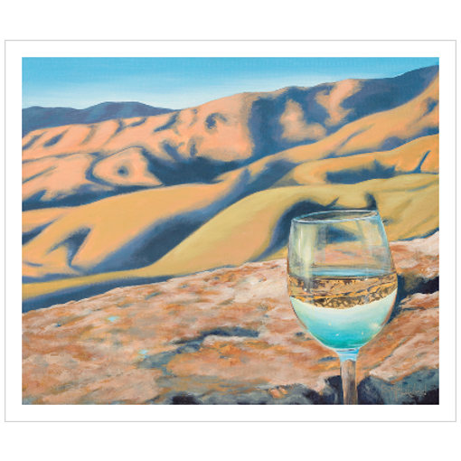 Archival print on matte paper of a glass of white wine refracting sunlit foothills under a bright blue sky.