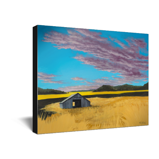 Archival print on canvas of a contemporary rural landscape painting of a rustic barn sitting in a yellow field with green hills in the distance under a blue sky filled with purple fluffy clouds. 