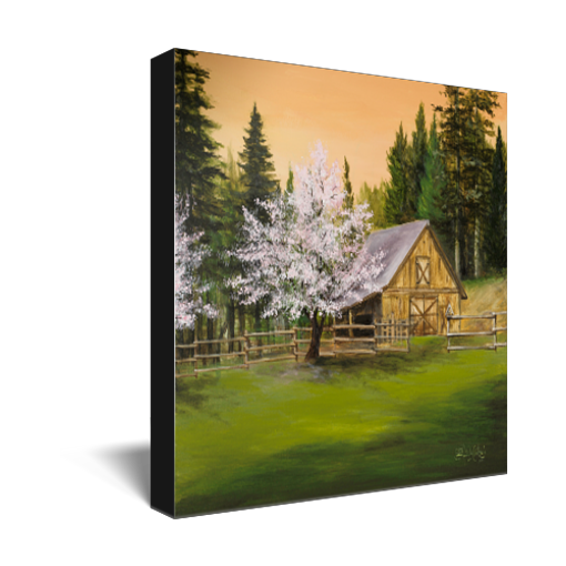 Archival print on canvas of a painting of a lush green mountain landscape, trees in spring blossom, and a rustic barn surrounded by evergreen pine trees under a soft peach colored sky. 