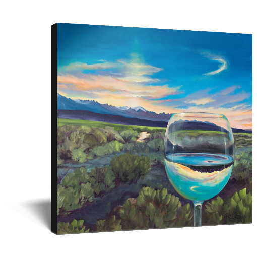 Archival print on canvas of a painting of a sagebrush landscape refracting in a glass of white wine under a blue evening sky with a mountain range on the horizon. 