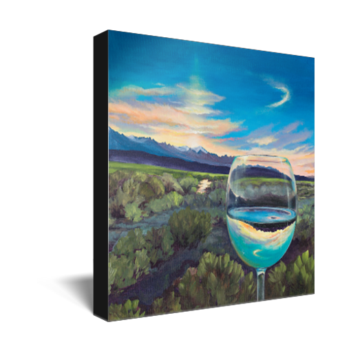Archival print on canvas of a painting of a sagebrush landscape refracting in a glass of white wine under a blue evening sky with a mountain range on the horizon. 