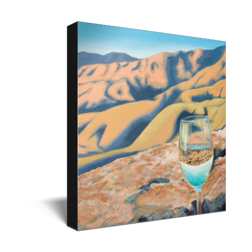 Archival print on canvas of a glass of white wine refracting sunlit foothills under a bright blue sky.